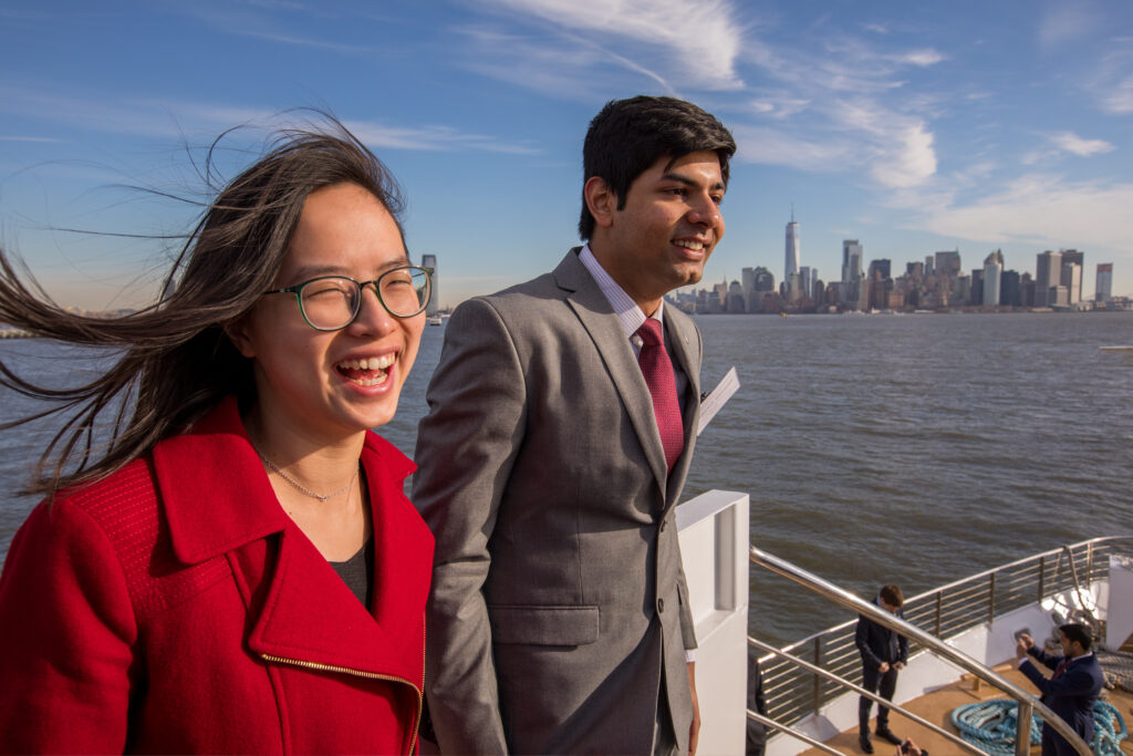 Students enjoy a river cruise with the New York City skyline in the background