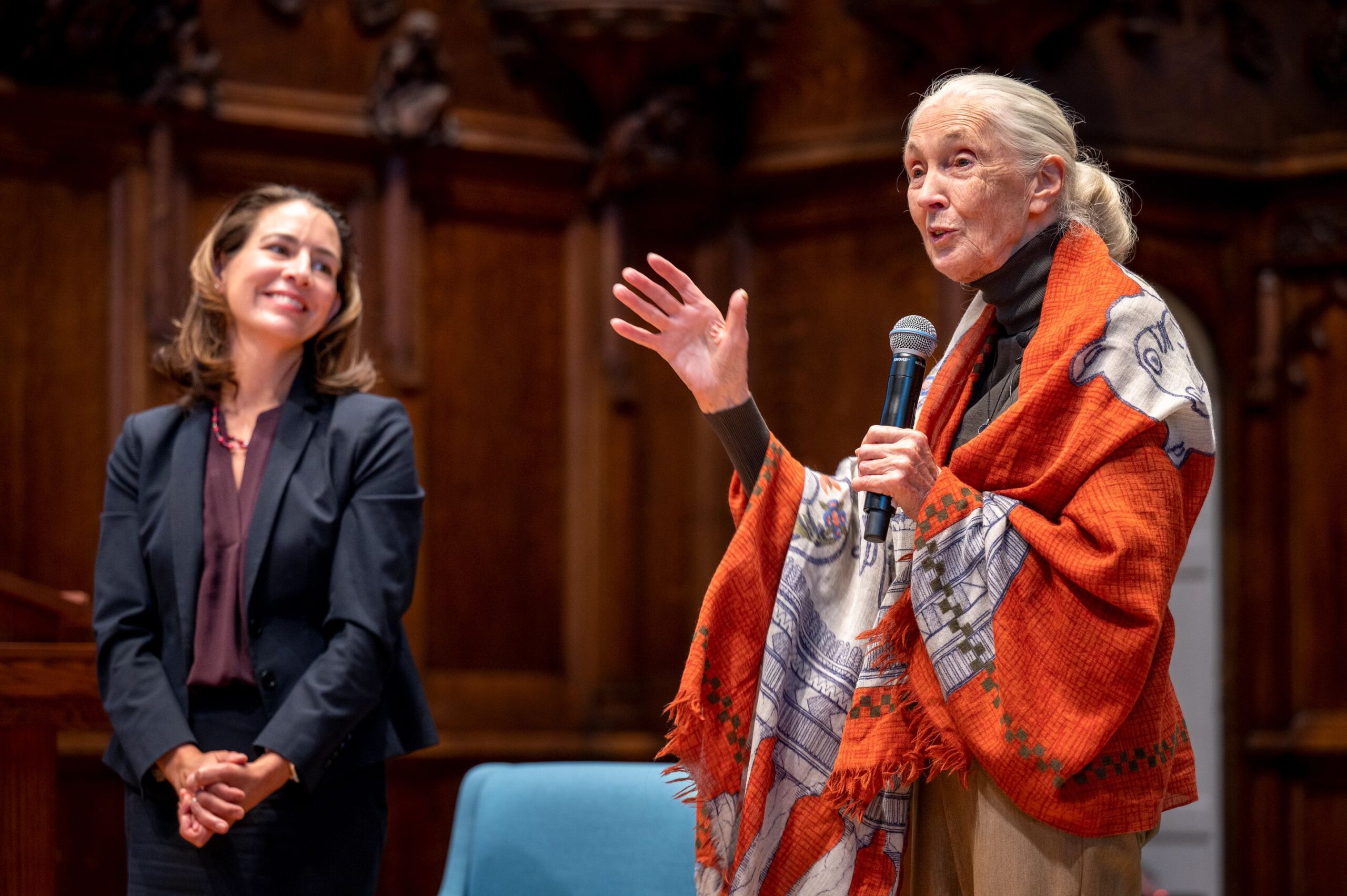 Dr. Crickette Sanz smiles as Dr. Jane Goodall talks