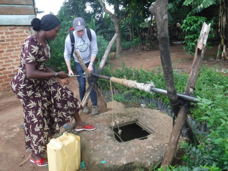 Two people operate a clean water well system